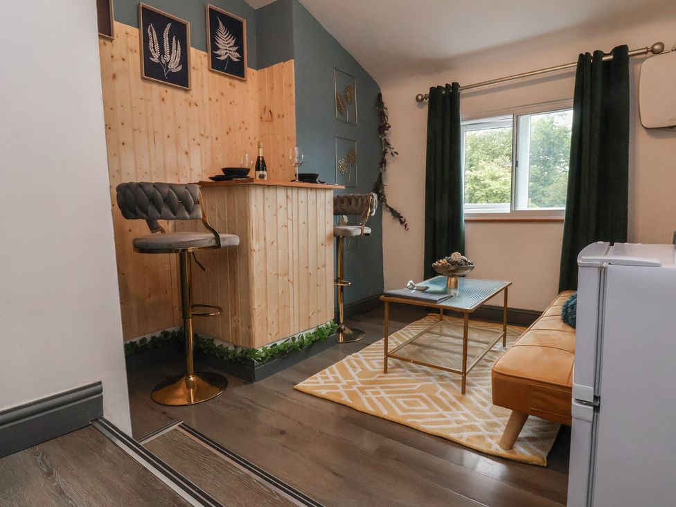 A living room with a bar area and sofa at The Cloud Apartment 1 in Chester