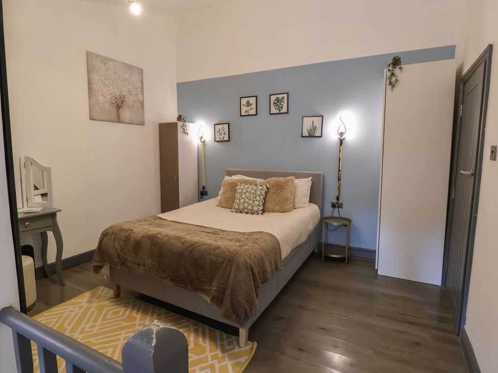 A bedroom with a bed and artwork on the wall at The Cloud Apartment 1 in Chester
