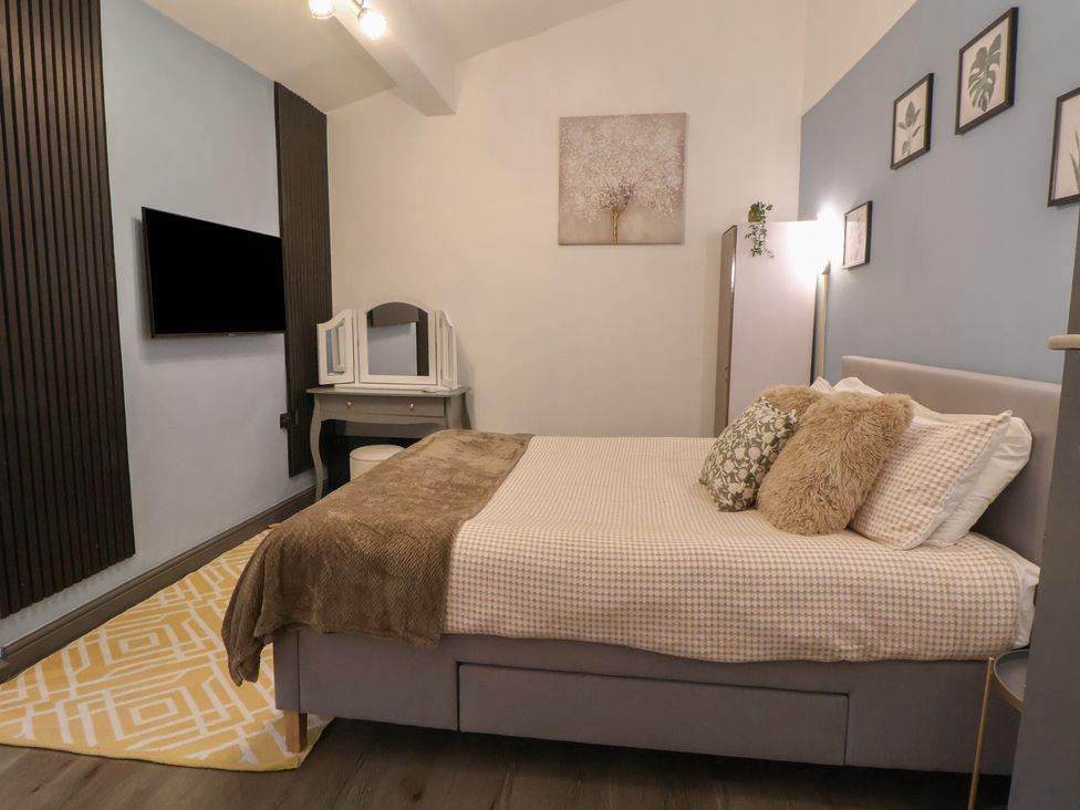 A bedroom with a bed and a dressing table at The Cloud Apartment 1 Chester