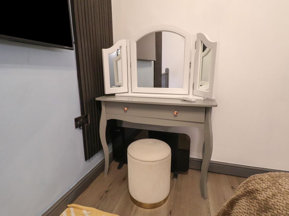 A vanity table with a mirror and stool at The Cloud Apartment 1 Chester