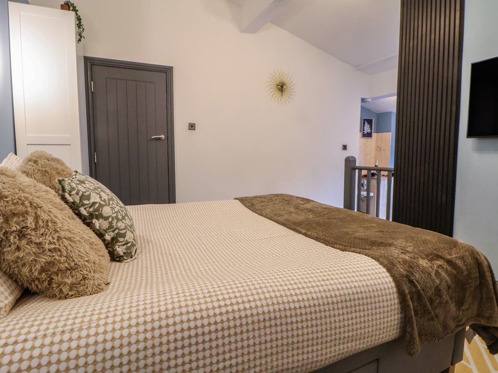 A bedroom with a bed and pillows at The Cloud Apartment 1 Chester