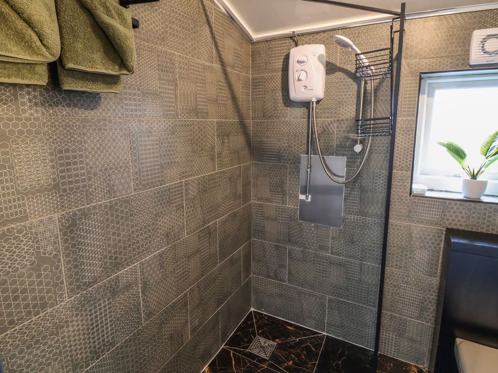 A bathroom with a shower and towels hanging at The Cloud Apartment 1 Chester