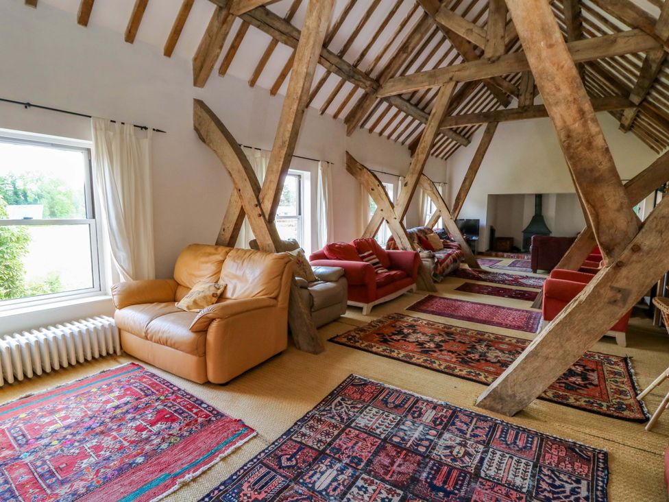 A living room with sofas and a fireplace at Gaer Hall in Welshpool
