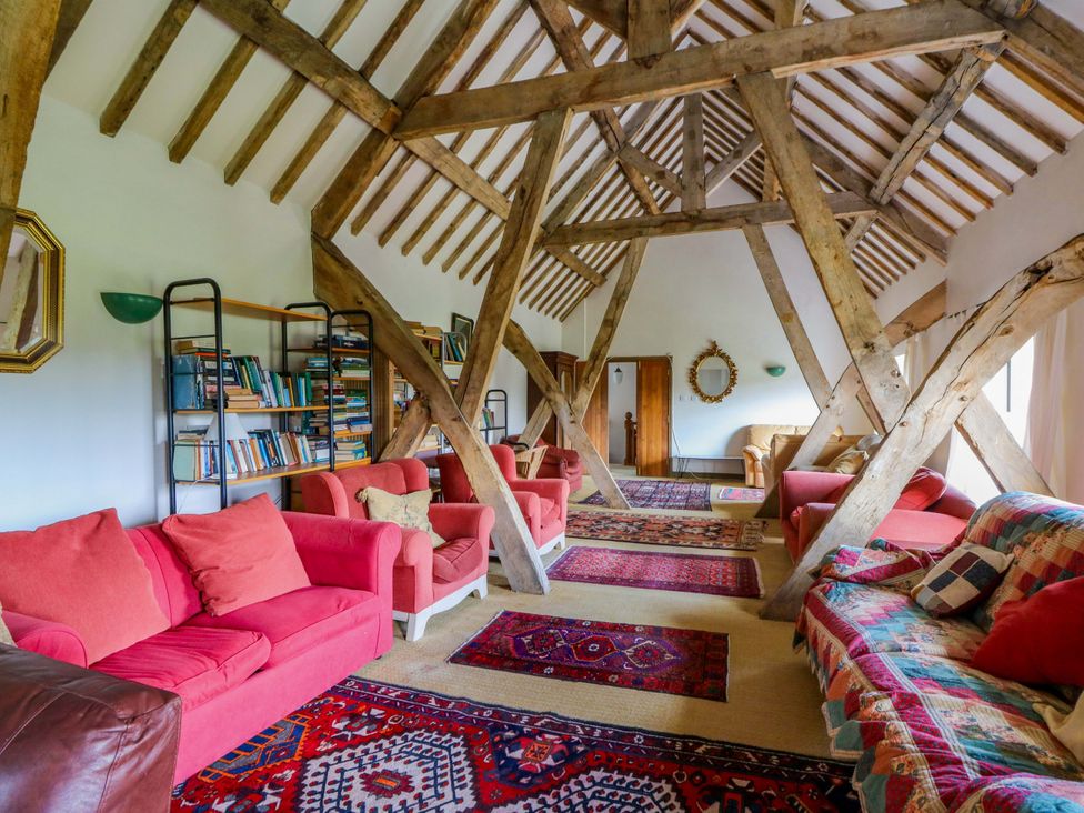A living room with sofas and a bookshelf at Gaer Hall in Welshpool