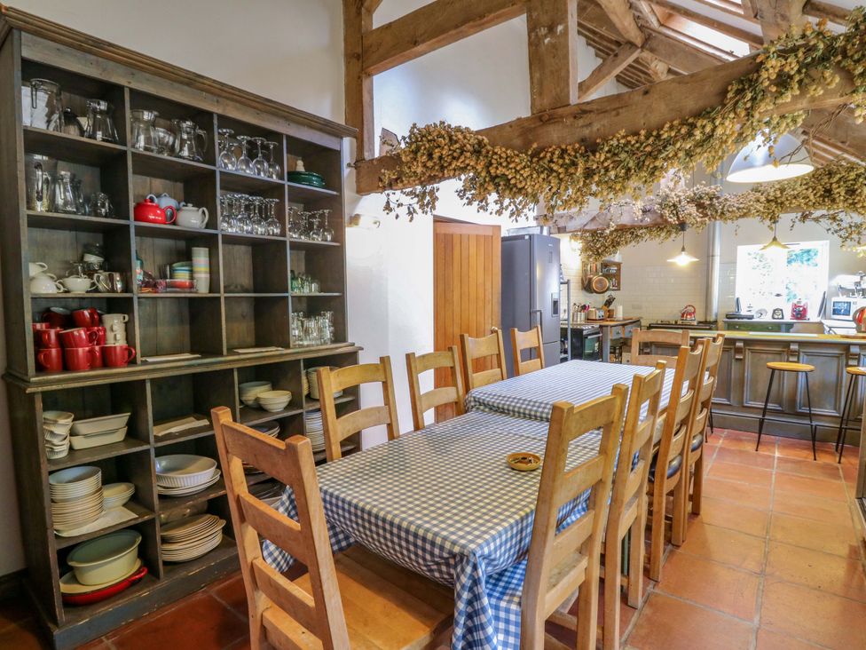 A kitchen with a table and chairs at Gaer Hall in Welshpool
