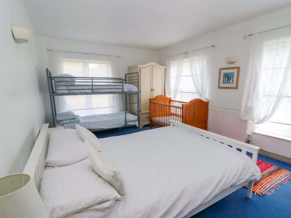A bedroom with double bed and bunk beds at Gaer Hall in Welshpool