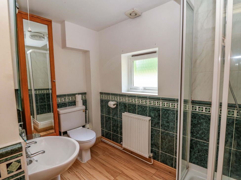 A bathroom with toilet, sink, and shower at Gaer Hall in Welshpool