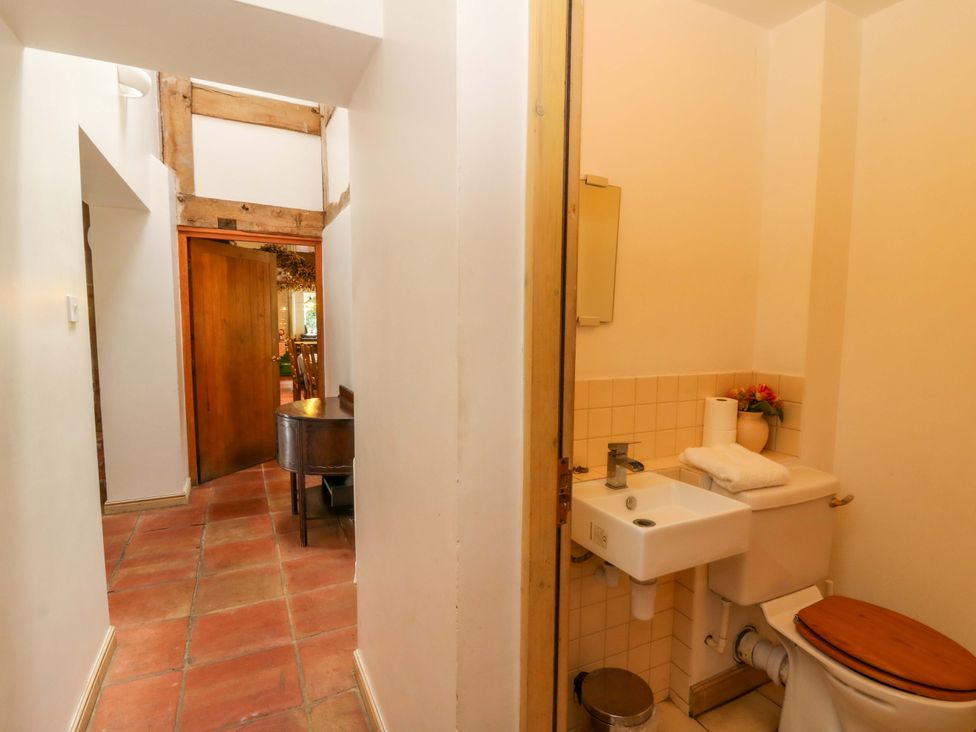 A bathroom with a toilet and sink at Gaer Hall in Welshpool