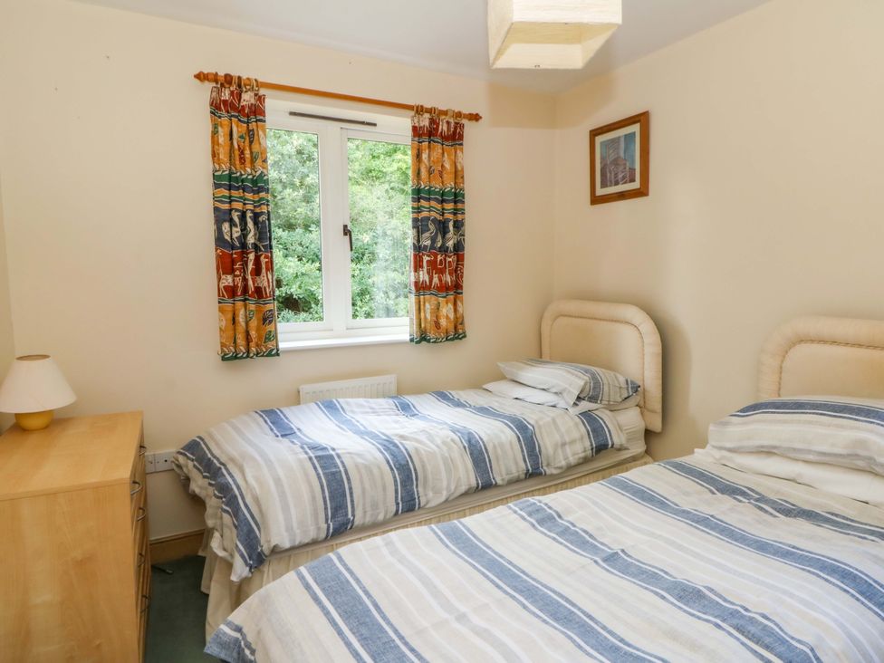 A bedroom with two beds and a window at Gaer Hall in Welshpool