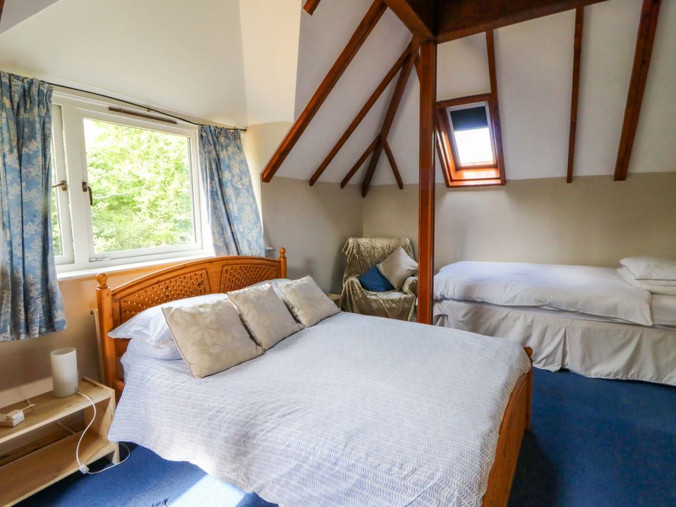 A bedroom with a double bed and a single bed at Gaer Hall in Welshpool