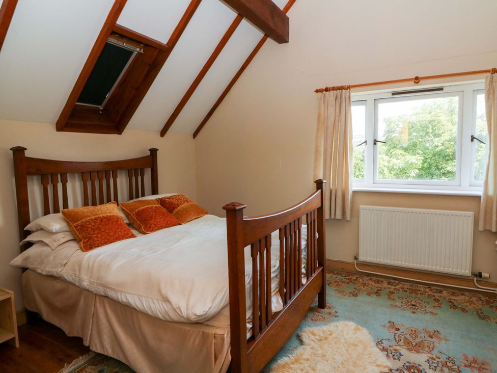 A bedroom with a bed and window at Gaer Hall in Welshpool