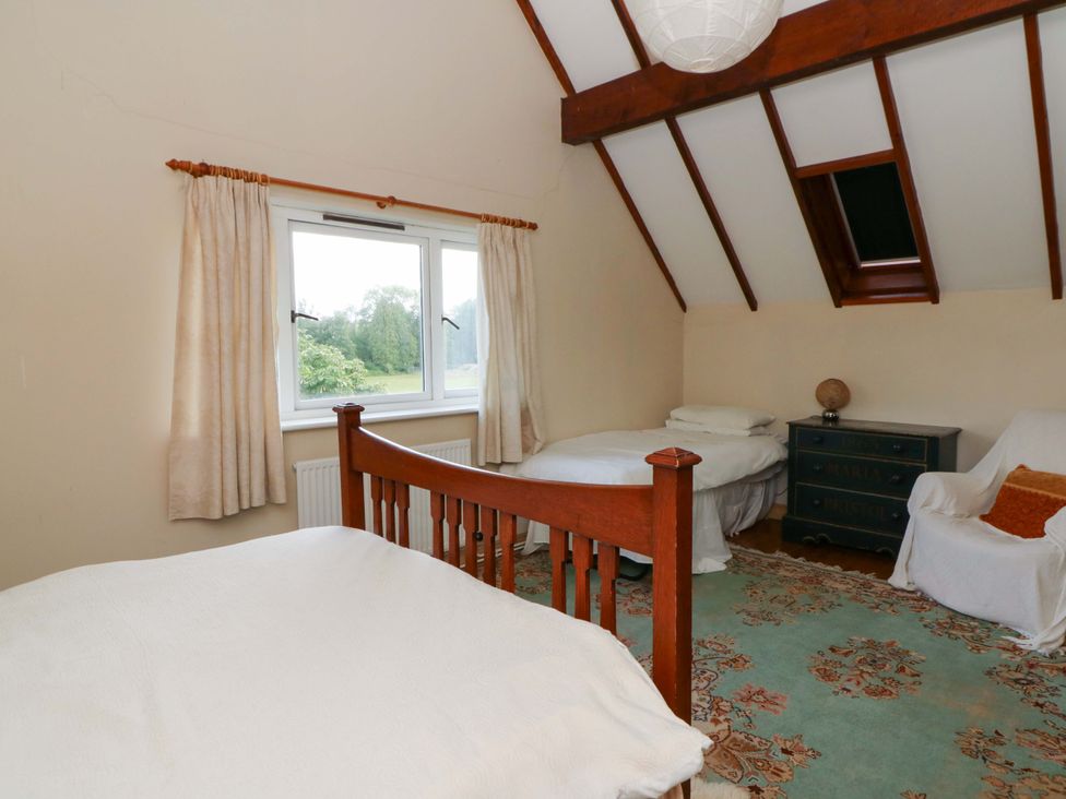 A bedroom with two beds and a window at Gaer Hall in Welshpool