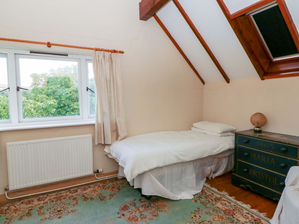 A bedroom with a single bed and a nightstand at Gaer Hall in Welshpool