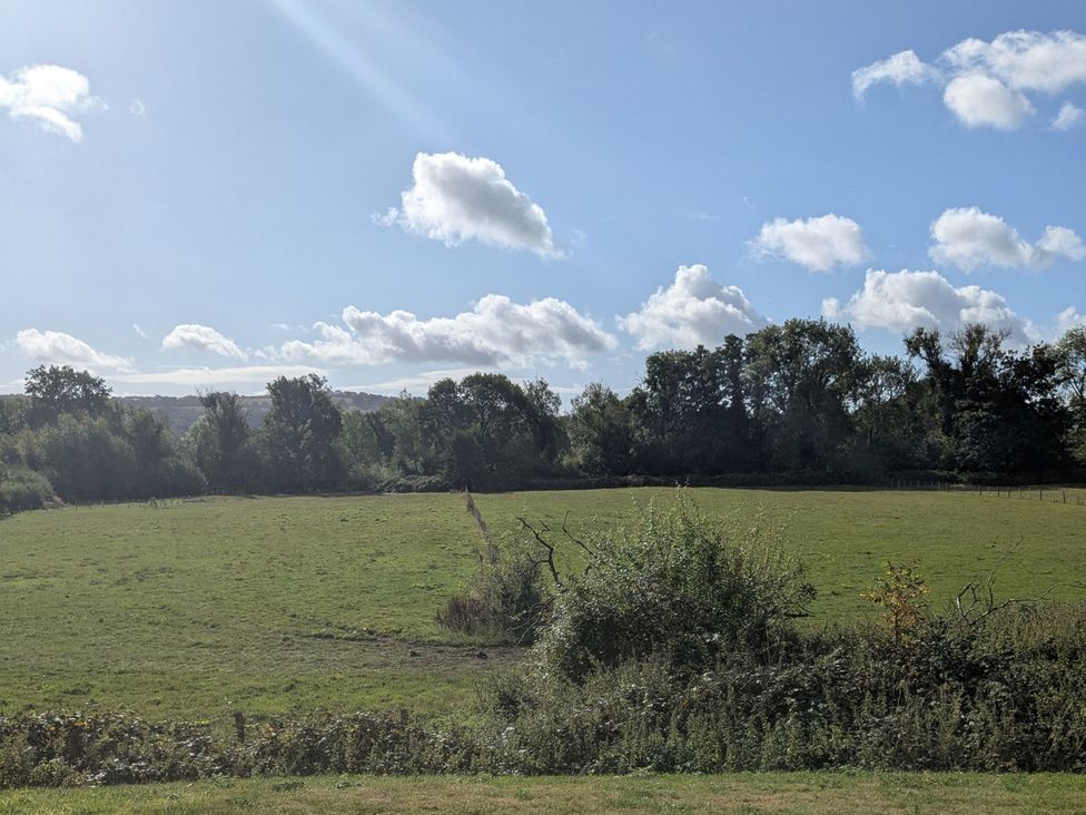 A landscape view with trees and a clear sky at Gaer Hall in Guilsfield
