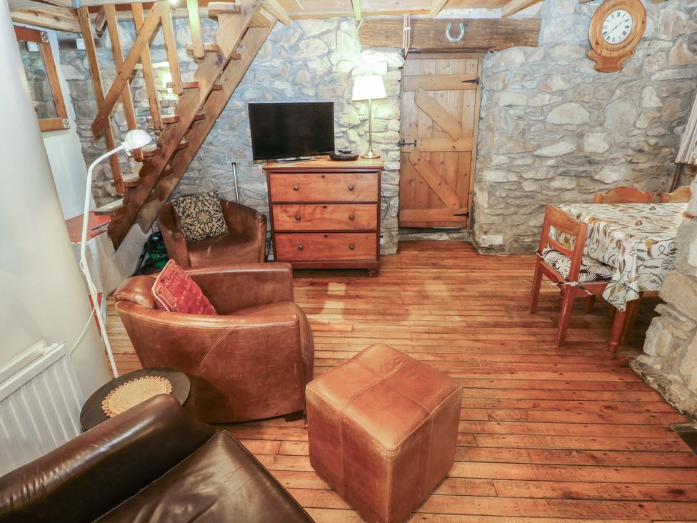 A living room with a television and a chest of drawers at Penfeidr Newydd, Carningli Common, Newport, Pembrokeshire