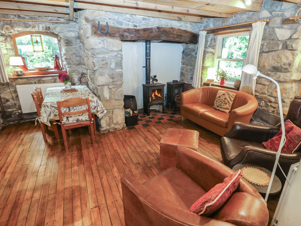 A living room with a table and chairs at Penfeidr Newydd, Carningli Common, Newport, Pembrokeshire