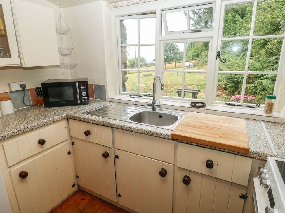 A kitchen with a sink and microwave at Penfeidr Newydd, Carningli Common, Newport, Pembrokeshire