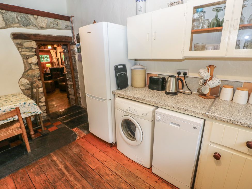 A kitchen with appliances including a refrigerator, washing machine, and dishwasher at Penfeidr Newydd, Carningli Common, Newport, Pembrokeshire