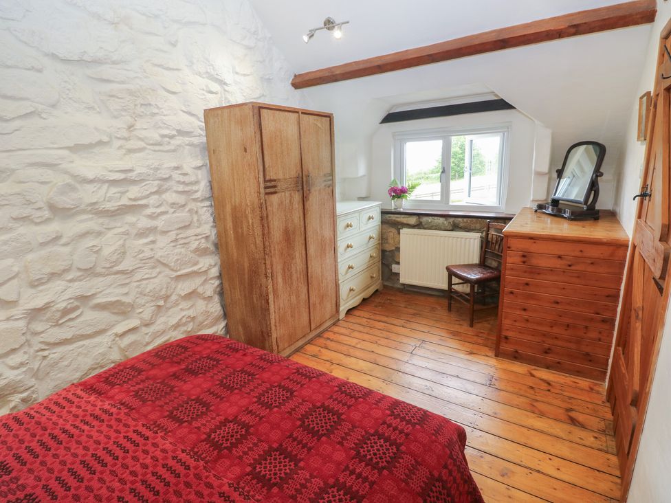 A bedroom with a bed and furniture at Penfeidr Newydd in Carningli Common, Newport, Pembrokeshire