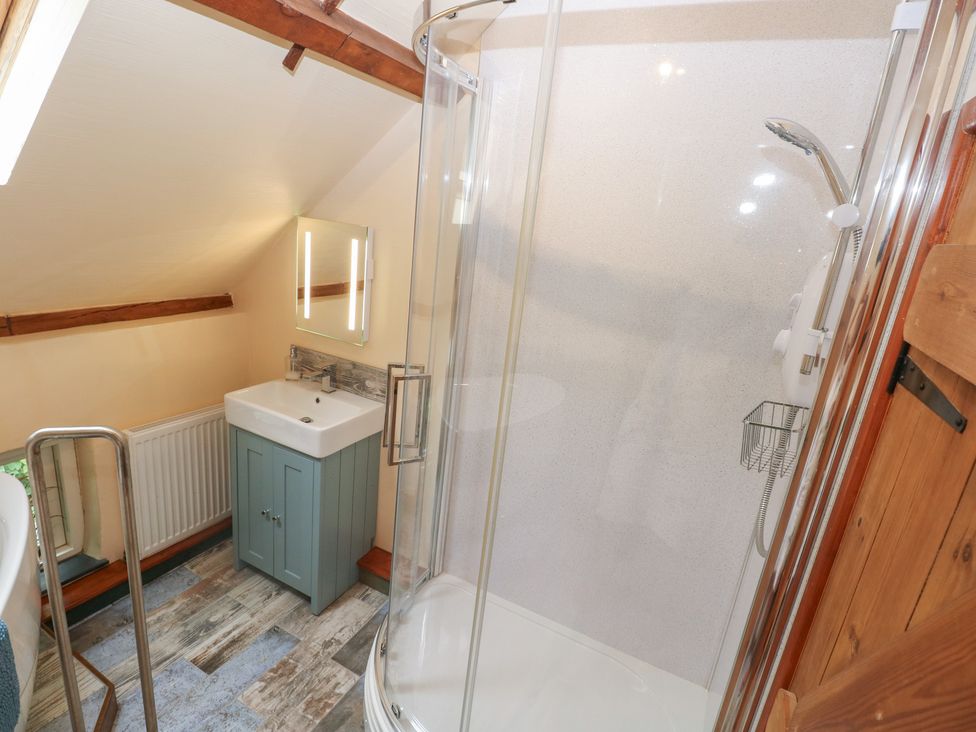 A bathroom with a shower and sink at Penfeidr Newydd, Carningli Common, Newport, Pembrokeshire