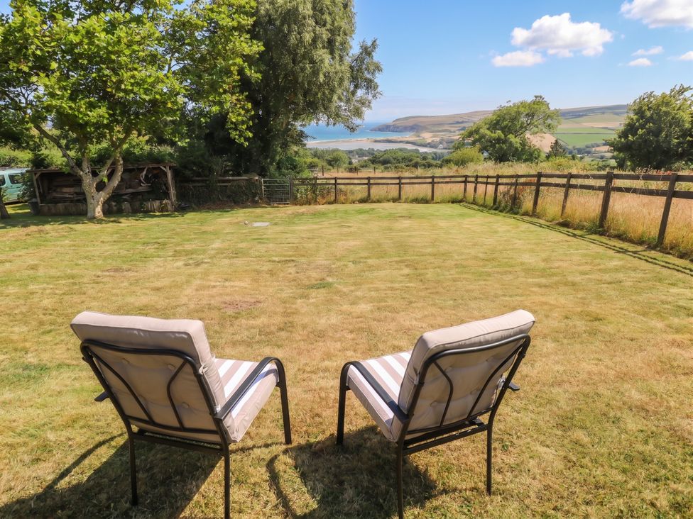 Two chairs on grass facing a scenic view at Penfeidr Newydd in Carningli Common, Newport, Pembrokeshire