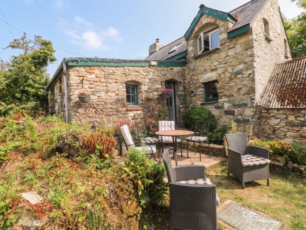 An outdoor seating area with a stone building at Penfeidr Newydd in Carningli Common, Newport, Pembrokeshire
