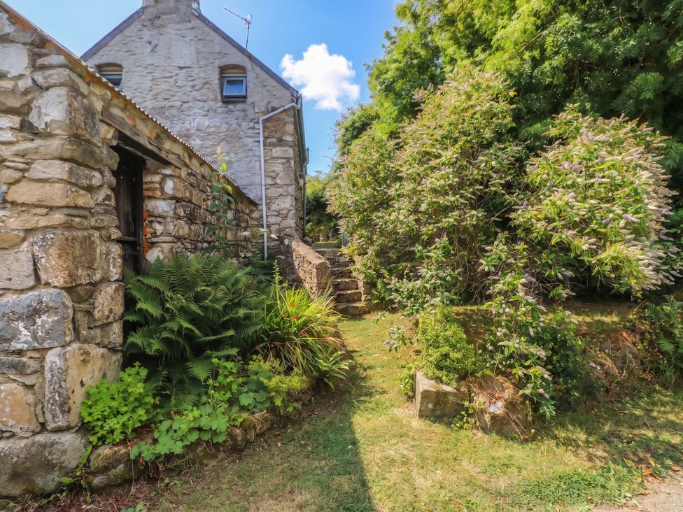 A garden area with stone building and steps at Penfeidr Newydd in Carningli Common, Newport, Pembrokeshire