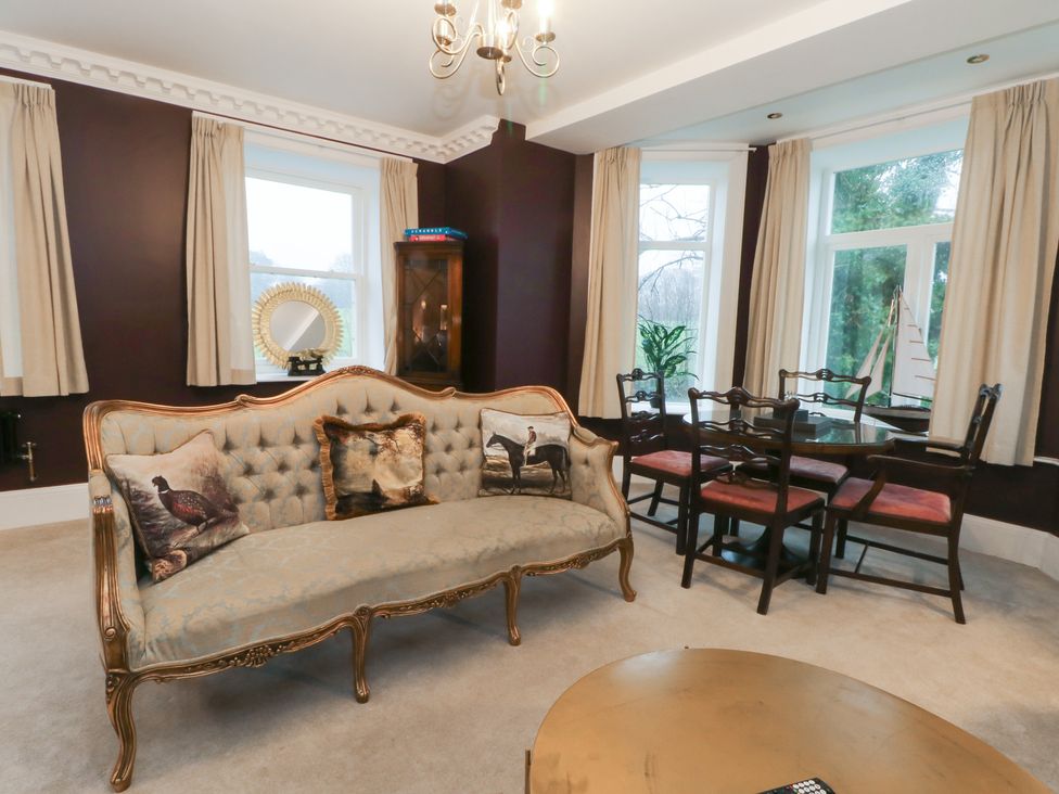 A dining room with a sofa and dining table at Alexander Cabus near Garstang