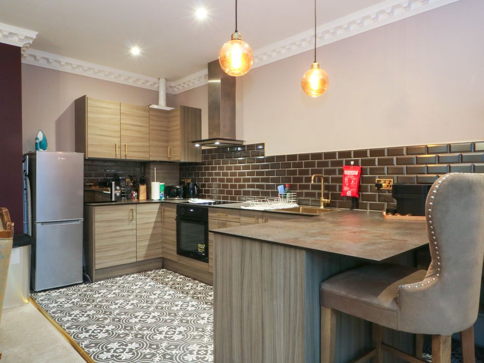 A kitchen with cabinets, sink and stove at Alexander near Garstang