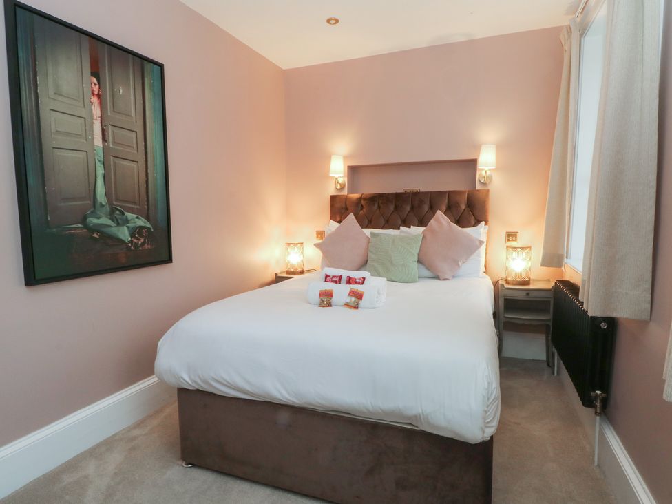 A bedroom with a bed and artwork at Alexander, Cabus near Garstang