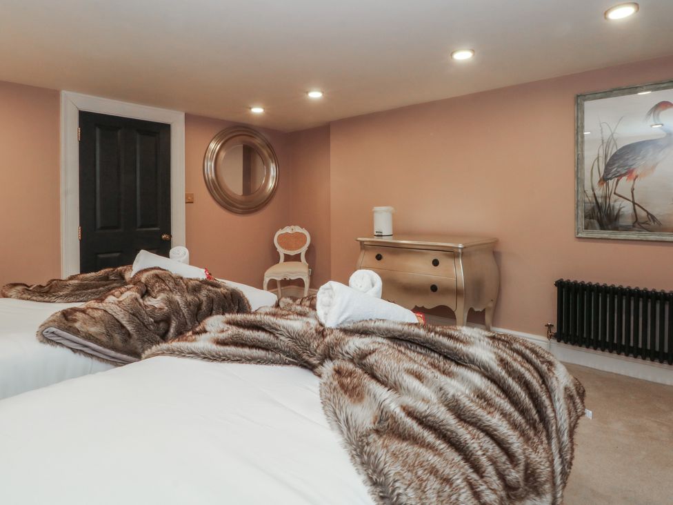 A bedroom with two beds and a dresser at Alexander in Cabus near Garstang