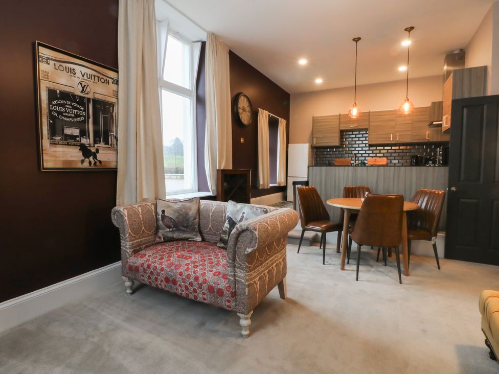 A living room with a sofa and dining area at The Hyde in Cabus near Garstang