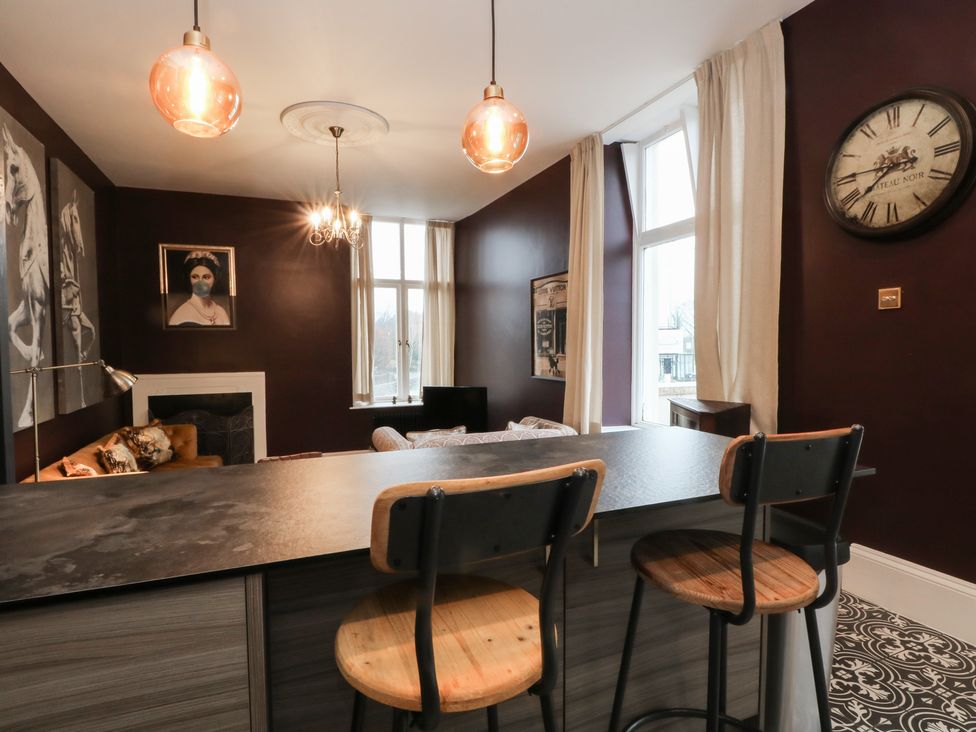 A living room with bar stools and a sofa at The Hyde in Cabus near Garstang