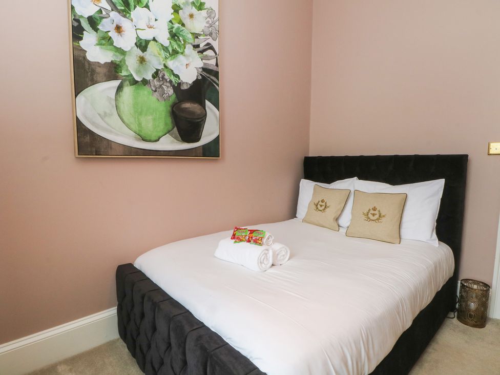 A bedroom with a bed and a painting on the wall at The Hyde Cabus near Garstang