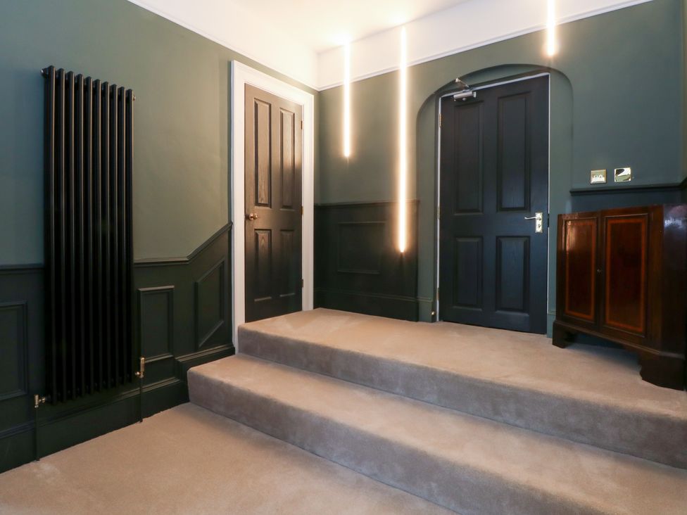 A hallway with steps and a cabinet at The Hyde in Cabus near Garstang