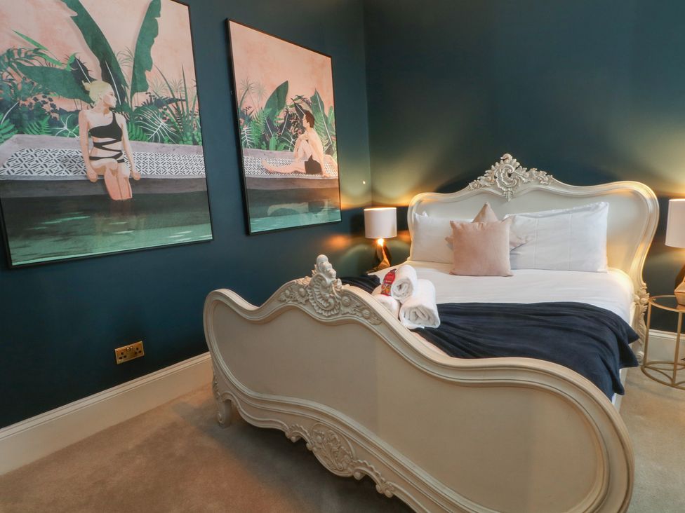 A bedroom with a bed and artwork on the walls at The Hyde in Cabus near Garstang