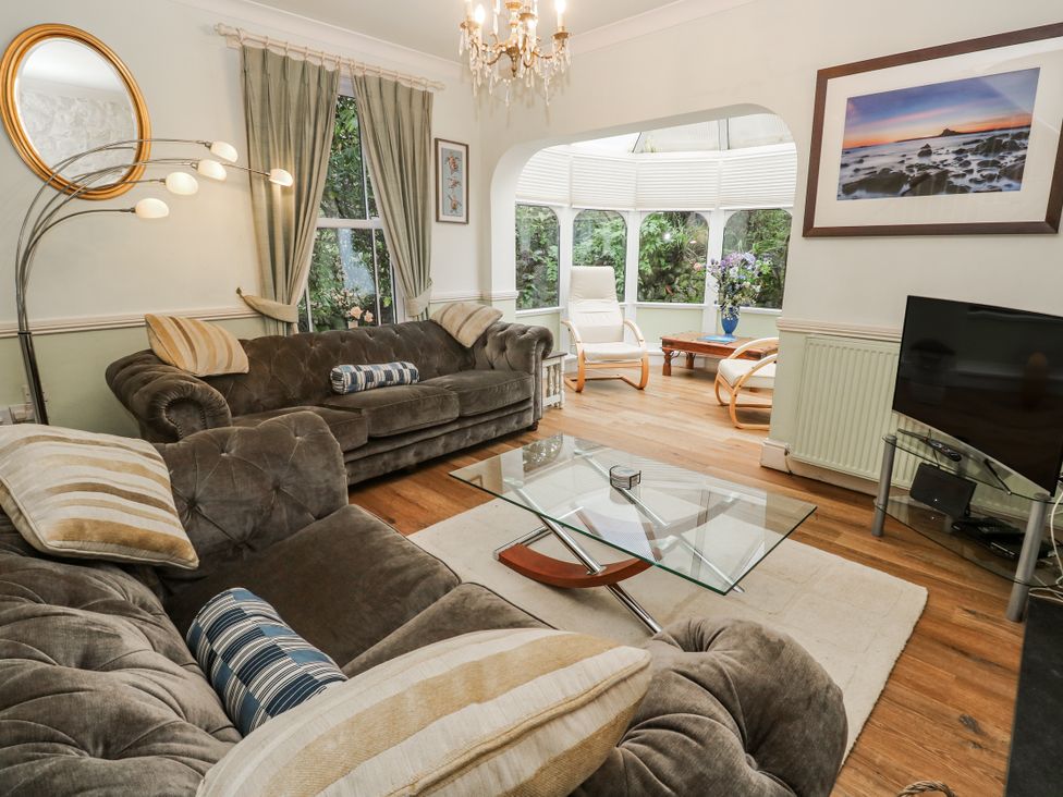 A living room with sofas and a coffee table at Glenside House in Carbis Bay