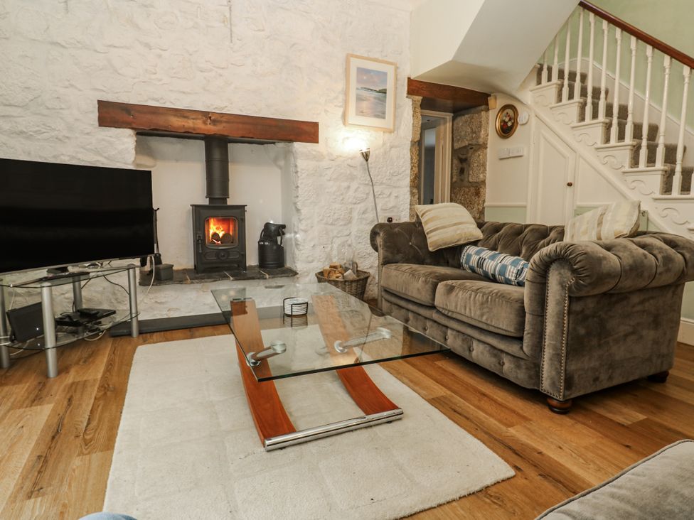 A living room with a sofa and coffee table at Glenside House in Carbis Bay