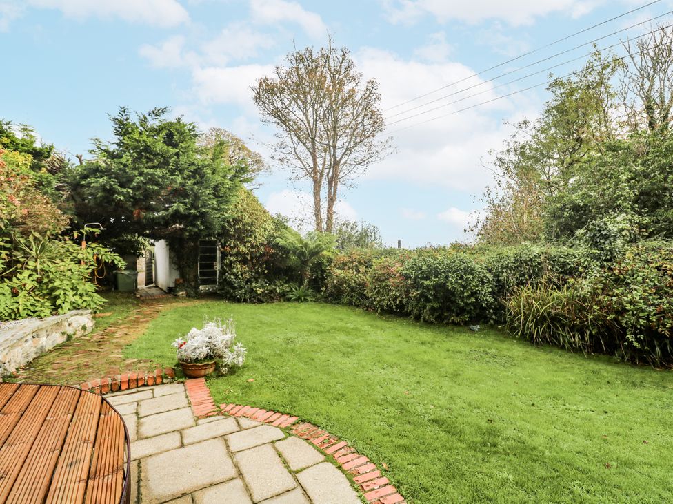 A garden with grass and plants at Glenside House in Carbis Bay