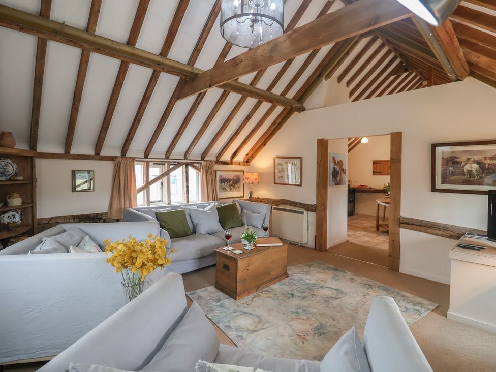 A living room with a sofa and coffee table at The Cow Shed in Chediston near Halesworth