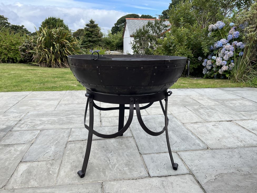 A fire pit on a stone patio at Riviere House in Hayle