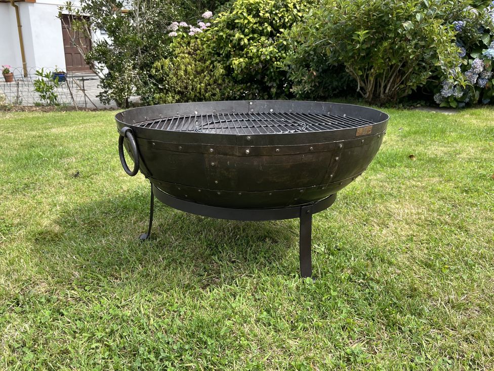 A fire pit on the grass at Riviere House in Hayle