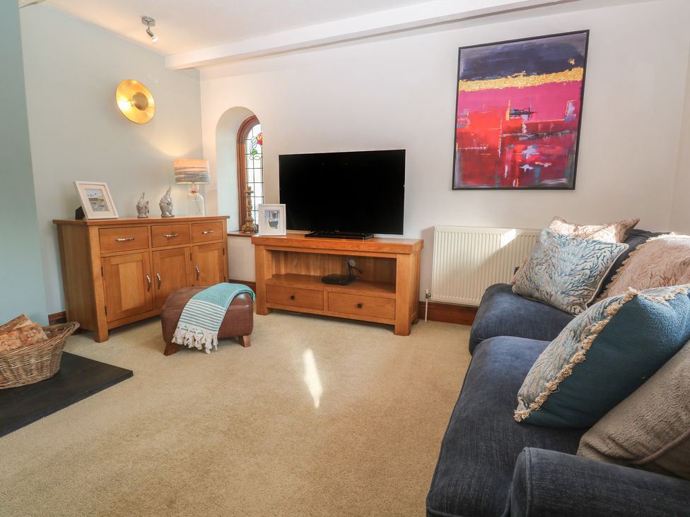 A living room with a sofa and television at Riviere House Hayle