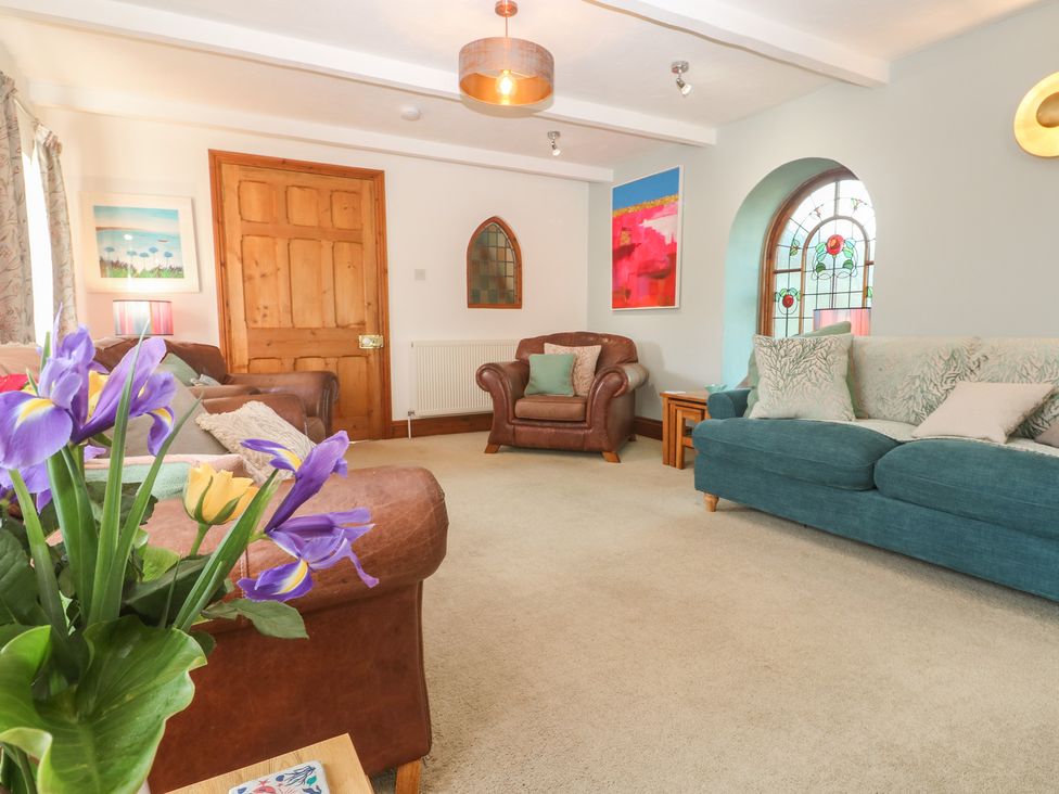 A living room with sofas and armchair at Riviere House Hayle