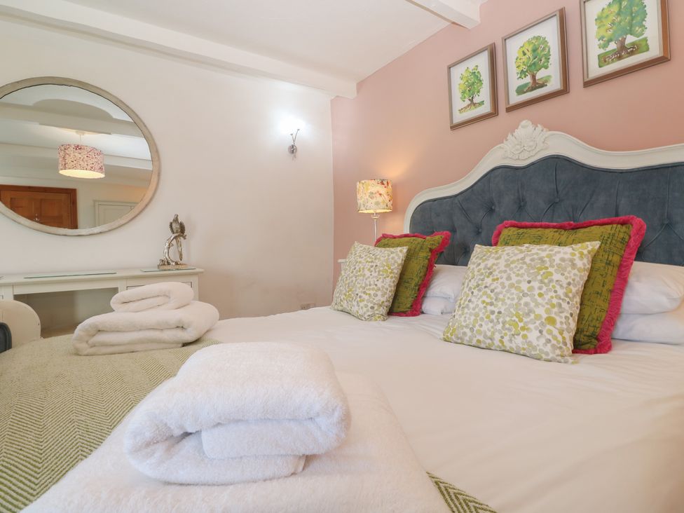 A bed with pillows and towels in a bedroom at Riviere House Hayle