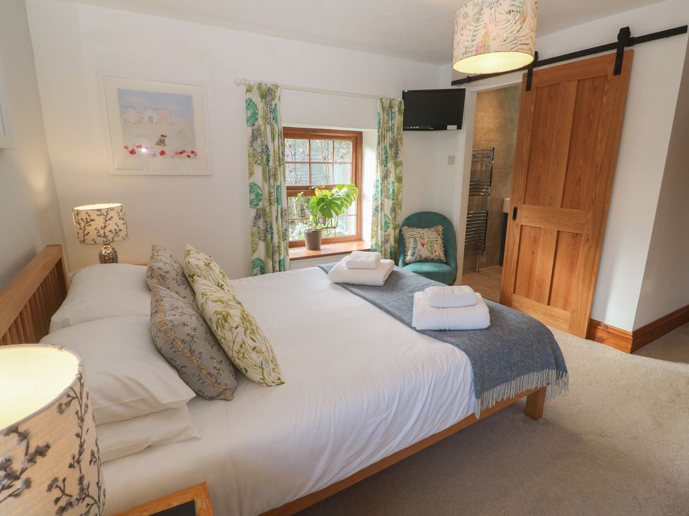 A bedroom with a bed and furniture at Riviere House in Hayle