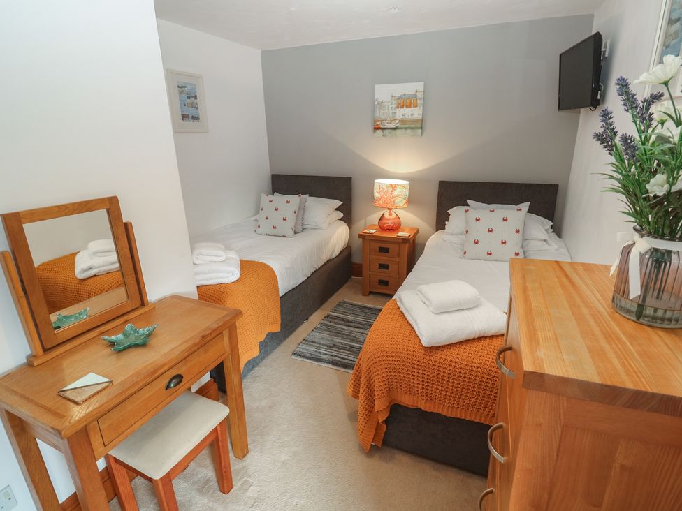 A bedroom with two beds and a dresser at Riviere House in Hayle