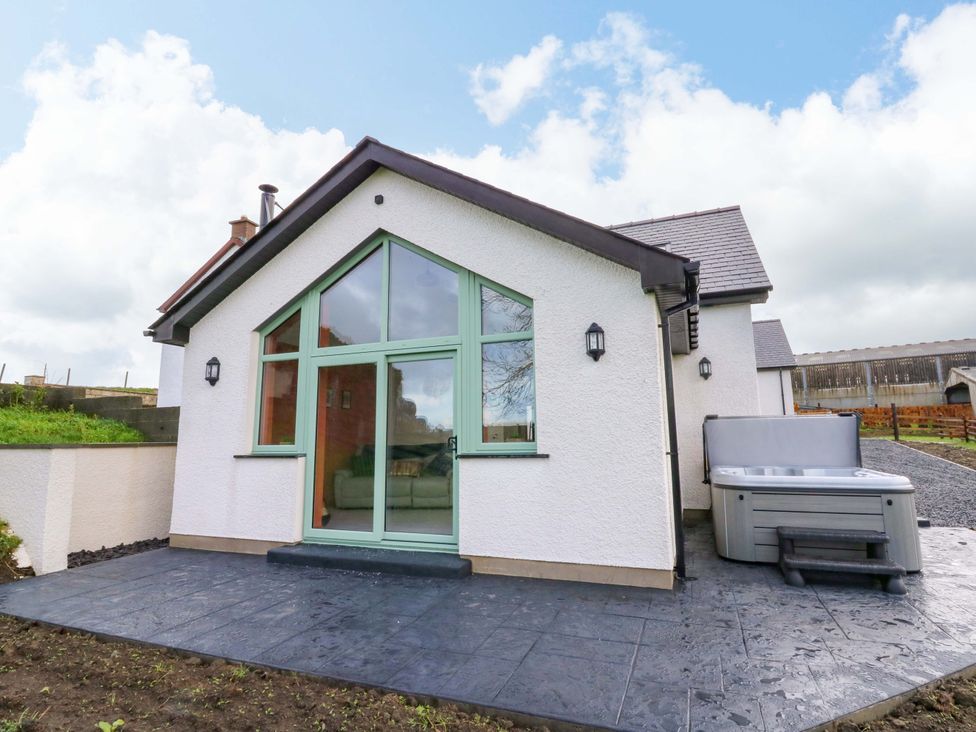 An outdoor view of a house with a spa at Y Stabal near Llanilar