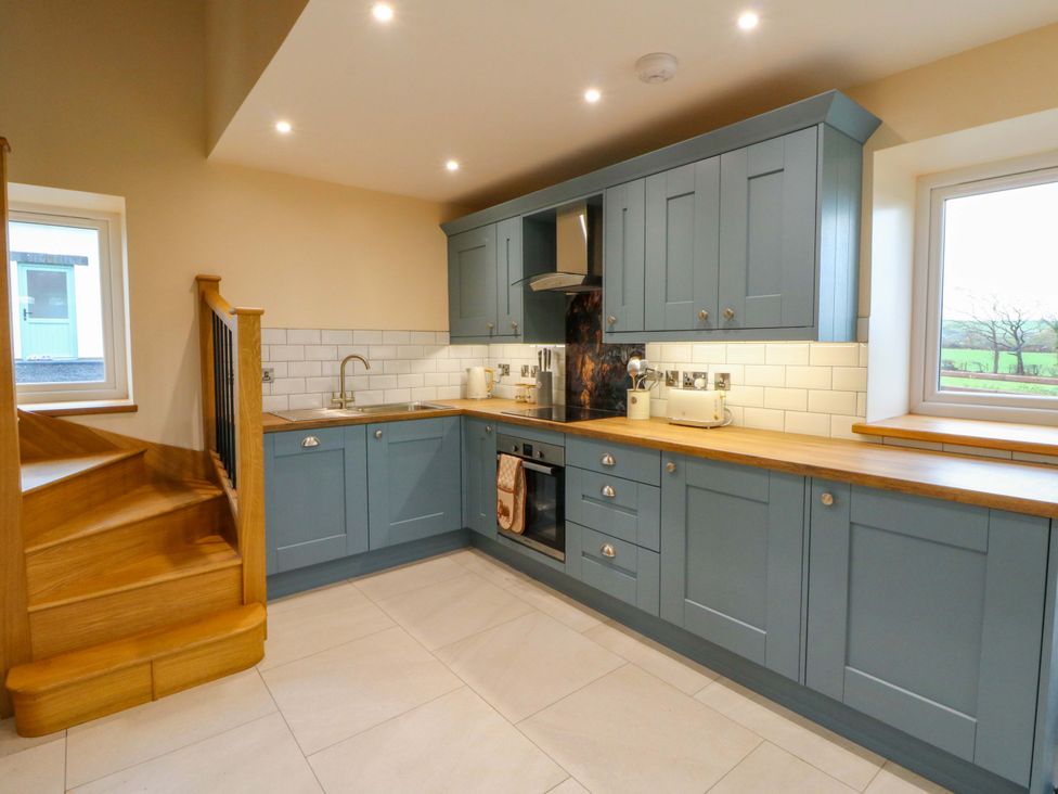 A kitchen with cabinets and a countertop at Y Stabal near Llanilar