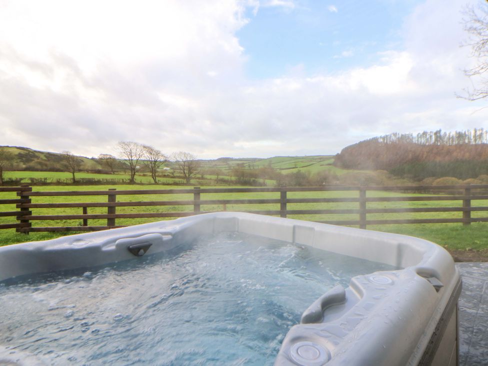 A hot tub with a landscape view at Y Stabal near Llanilar